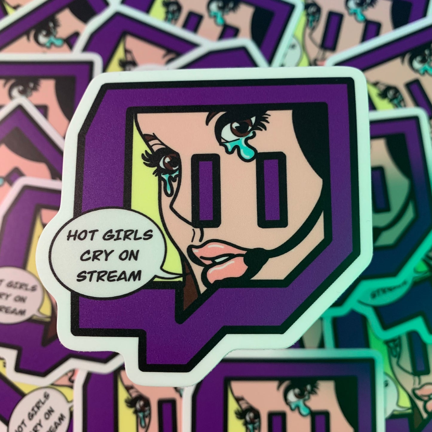 This sticker is in the shape of the twitch logo, with a cartoon woman in a comic book style crying within it, with "hot girls cry on stream" inside a talk bubble.