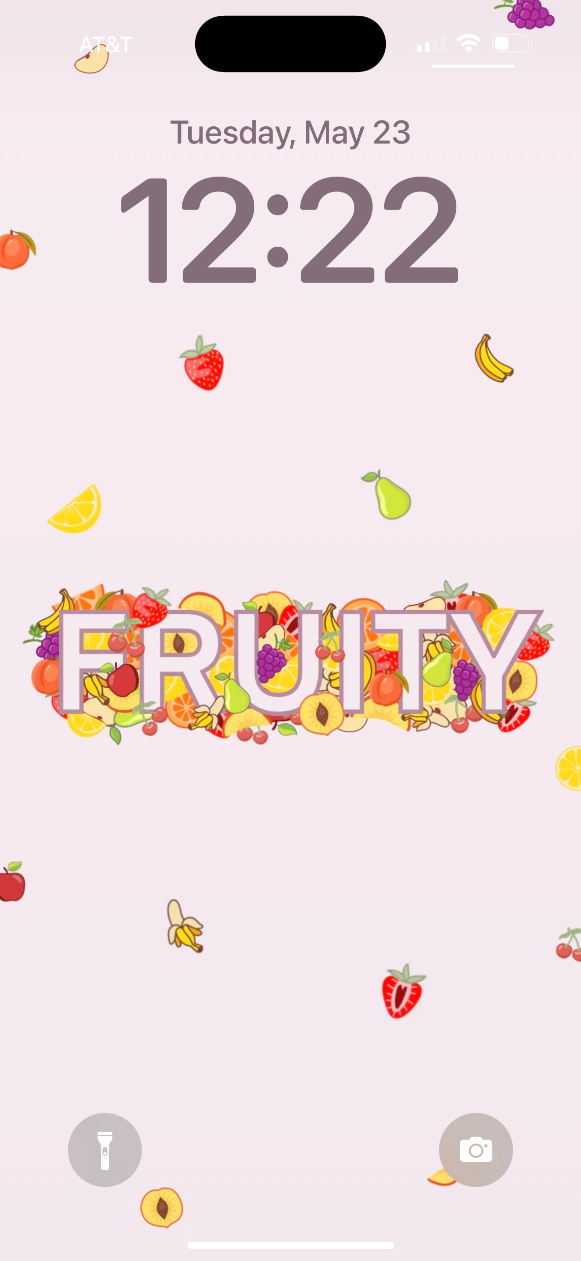 a screenshot of our "fruity" wallpaper phone design. This wallpaper features the word FRUITY in block letters surrounded by  various fruits.