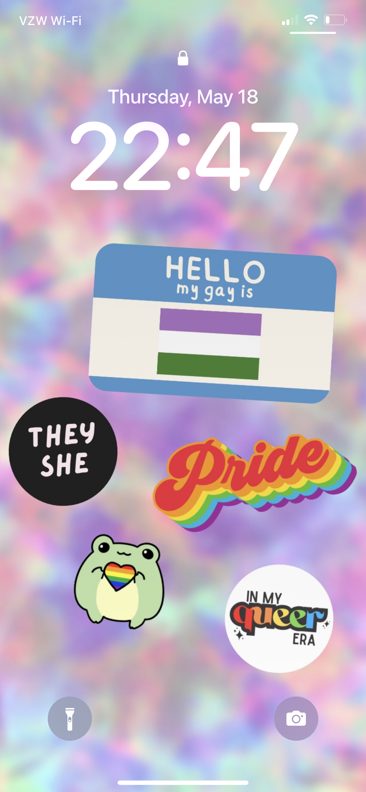 A screenshot of the pride wallpaper featuring the genderqueer flag and they/she pronouns.