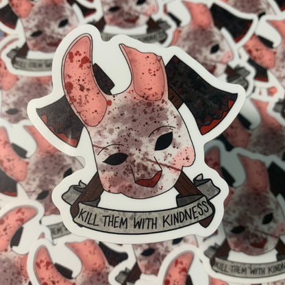A bloody bunny mask inspired by the Huntress from Dead by Daylight's with two bloody axes crossed behind it. Under the mask is a banner with the phrase "KILL THEM WITH KINDNESS" written on it.